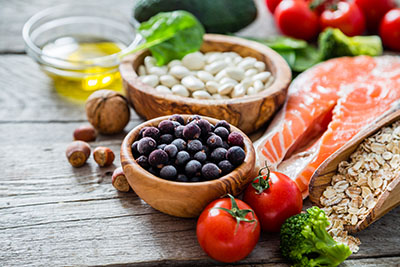 Picture of healthy food, including salmon, nuts and more on a table