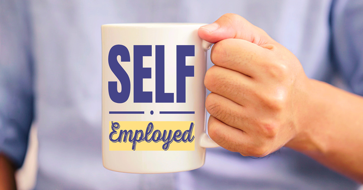 A person holding a mug that says, 'Self-employed.'