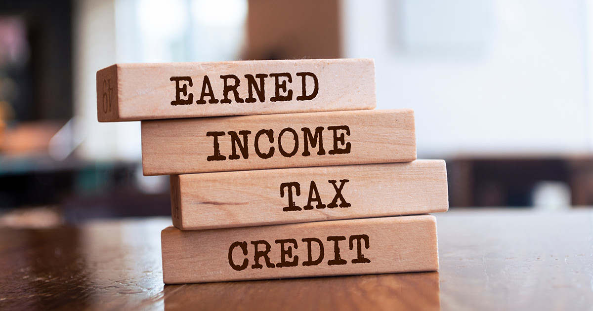 A stack of wooden blocks that say from top to bottom, "Earned. Income. Tax. Credit."