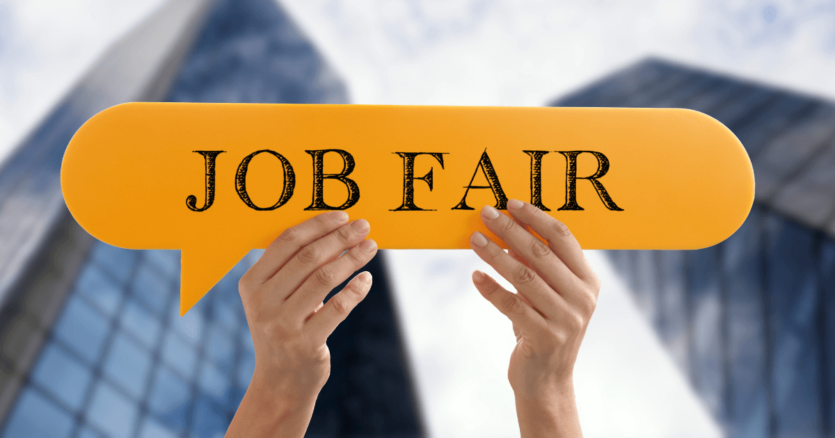 Pair of hands holding up a paper talk bubble in the air. The text in the talk bubble reads "Job Fair".