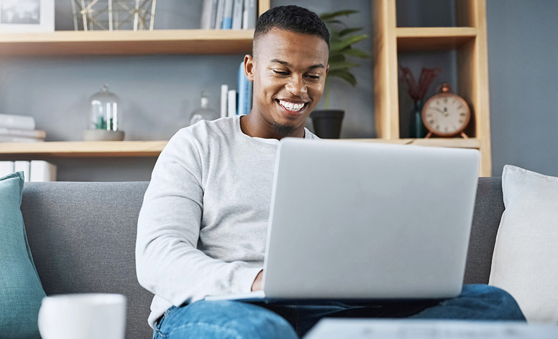 Man working on his laptop on the couch