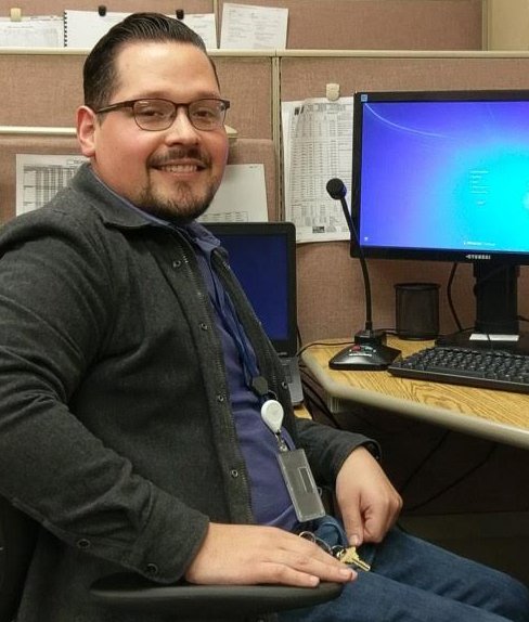 Image of Jesus at his work desk in front of a computer