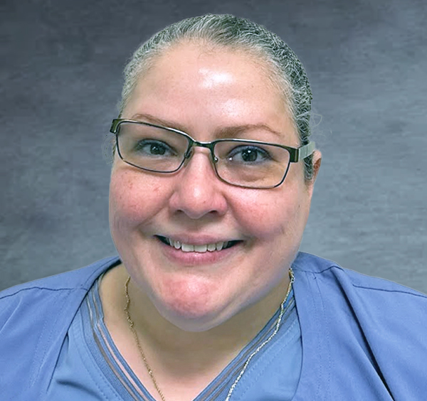 Frances, a Ticket to Work Success Story feature, in blue scrubs smiling at the camera.