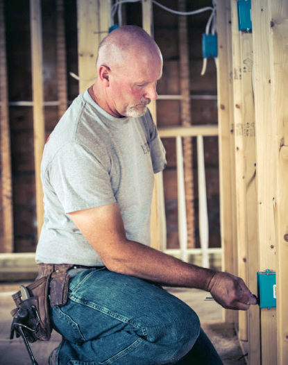 Photo of Marty installing electrical wiring Photo of Marty installing electrical wiring