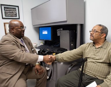 Photo of Robert shaking hand with another man