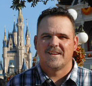 Photo of Jason with the Disney castle in the background