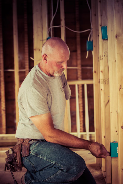 Photo of Marty installing electrical wiring