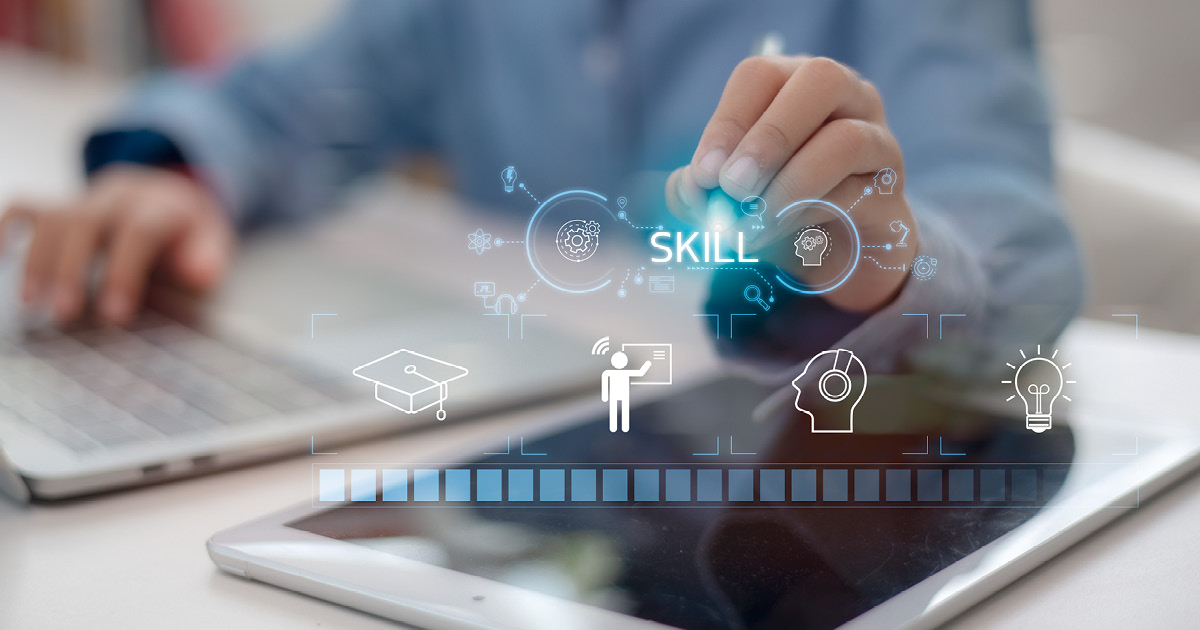 A person pointing to the holographic word “skill” with different icons under it.