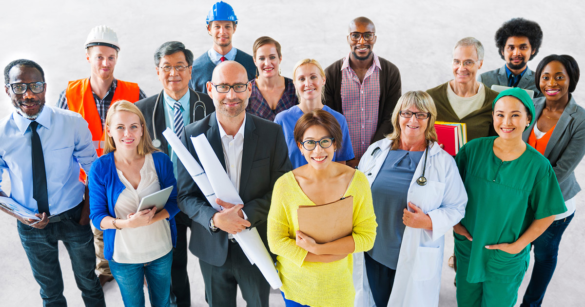 A group of people dressed in clothes and uniforms representing a variety of different occupations.