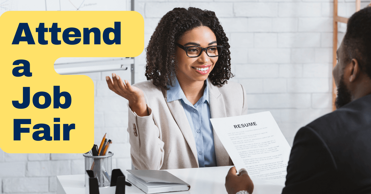 Two people at a desk sitting across from each other. Wording at left reads “Attend a Job Fair” on a yellow background.