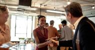 Two people shaking hands at an event.