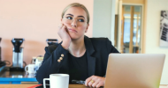 Woman bored at her desk in front of her laptop