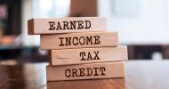 A stack of wooden blocks that say from top to bottom, “Earned. Income. Tax. Credit.” 